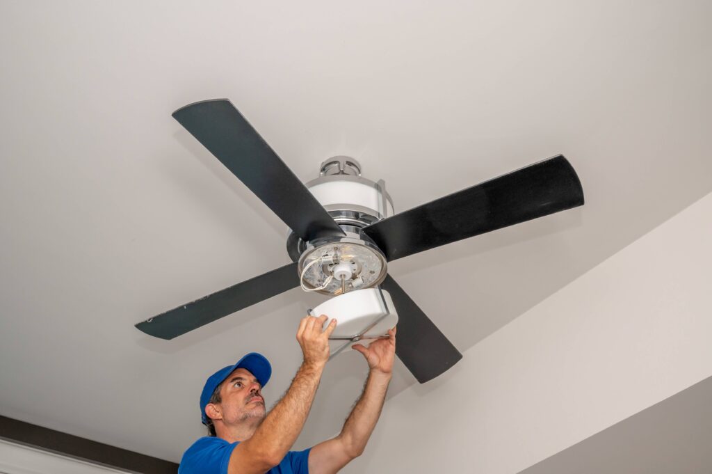 Ceiling Fan being installed by a man